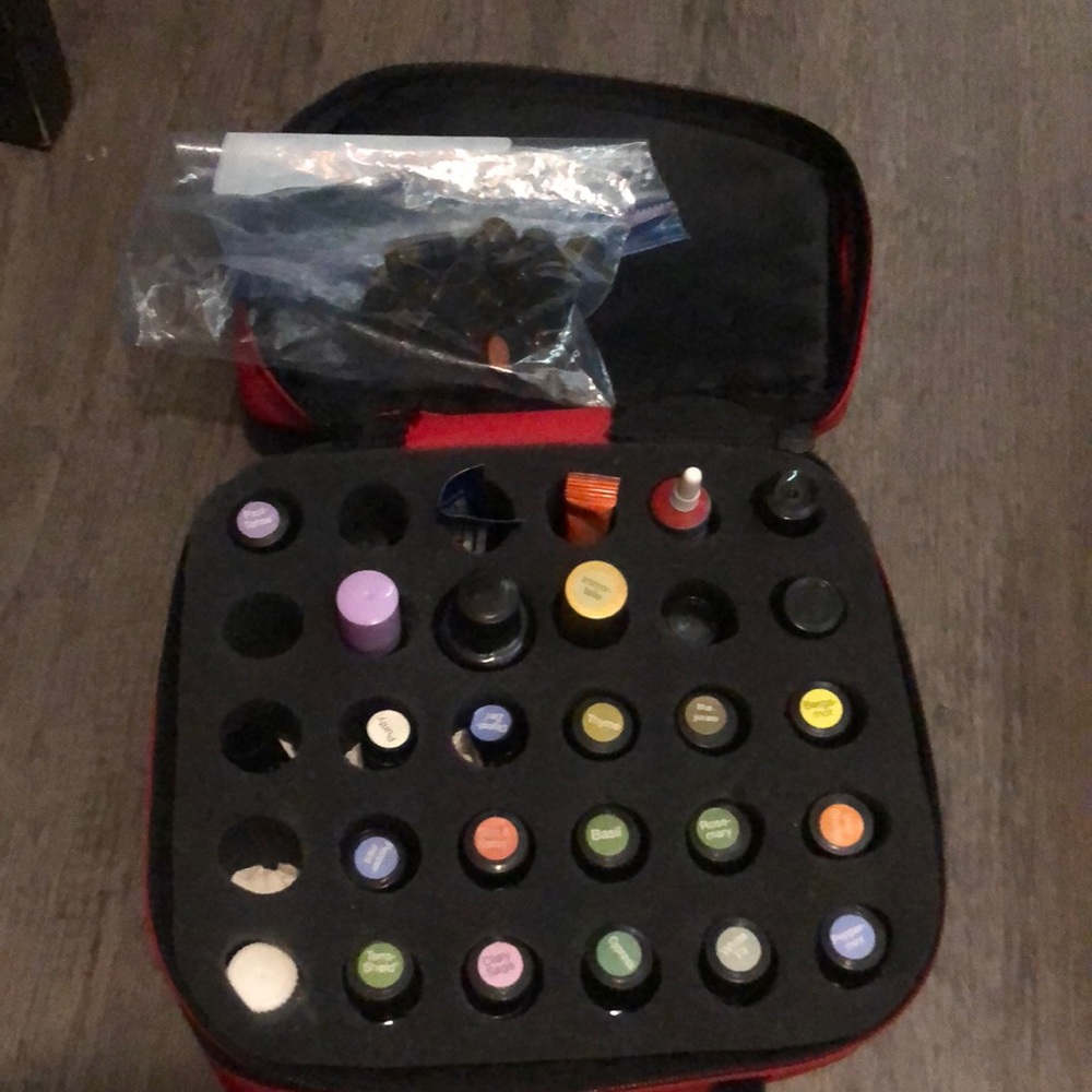 Assortment of Doterra and Young Living essential oils. Includes red zipper case.